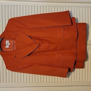 Orange suit with lined jacket and lined straight skirt with 2 back kick pleats.